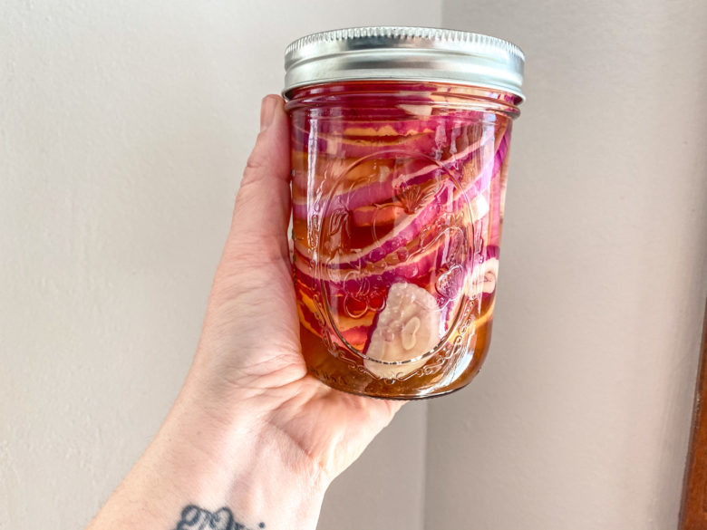Pickled red onion in a glass jar. 