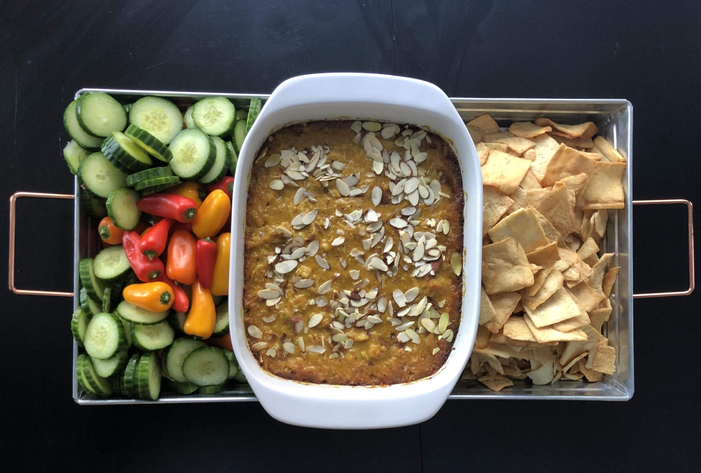 CHicken curry dip with pita chips, sweet peppers, and cucumbers. 